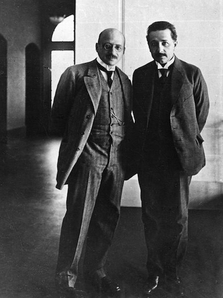 Chemist Fritz Haber and physicist Albert Einstein standing together in suits posing for a photograph.