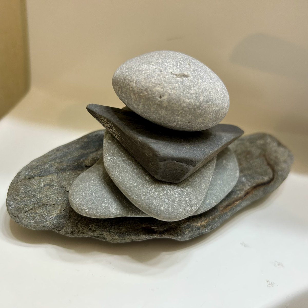 sparkplugcoach's tweet photo. New stone stack in our main bathroom - the bottom one is from the Atlantic in Maine, all the rest are from Lake Erie in New York. Always peaceful to see - and always peaceful to re-stack when our cat Neko knocks them over. Life is good! ##stonestacking #mindfulness ##lifeisgood https://t.co/ZvEn0yRsPi
