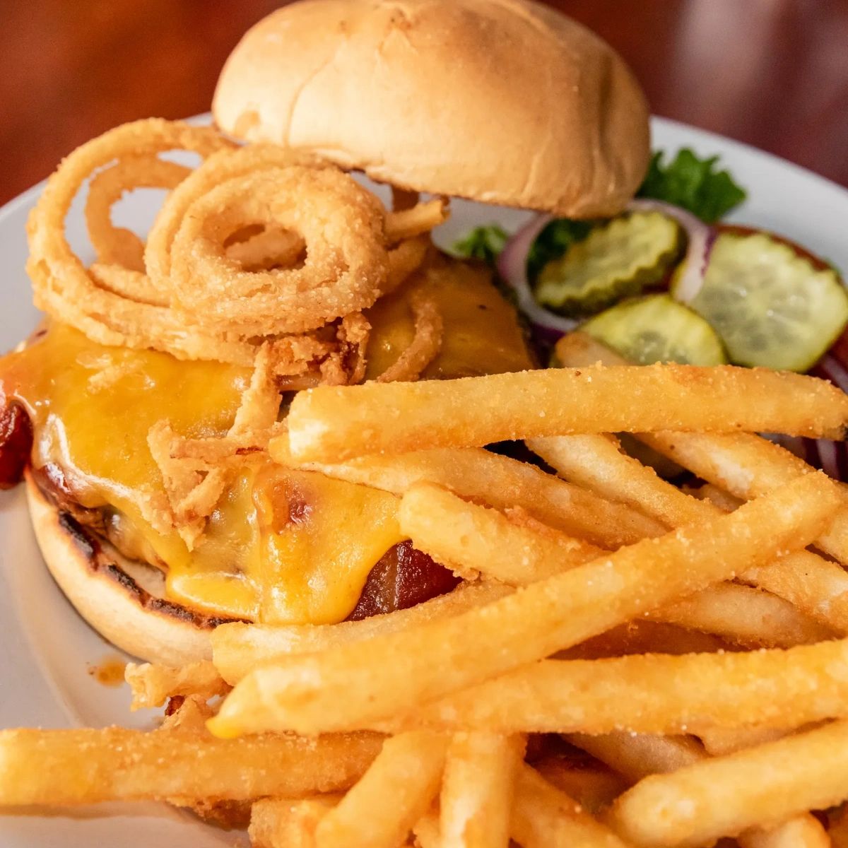 PizzeriaUnion's tweet photo. BBQ sauce, thick-cut bacon, sharp cheddar cheese, and fried onion strings: Now, that's what we call a winning combination. Check out our burger menu online, and let us know which one you're excited to try in the comments below. https://t.co/172UxXUeNm https://t.co/DyjIAjH2cq