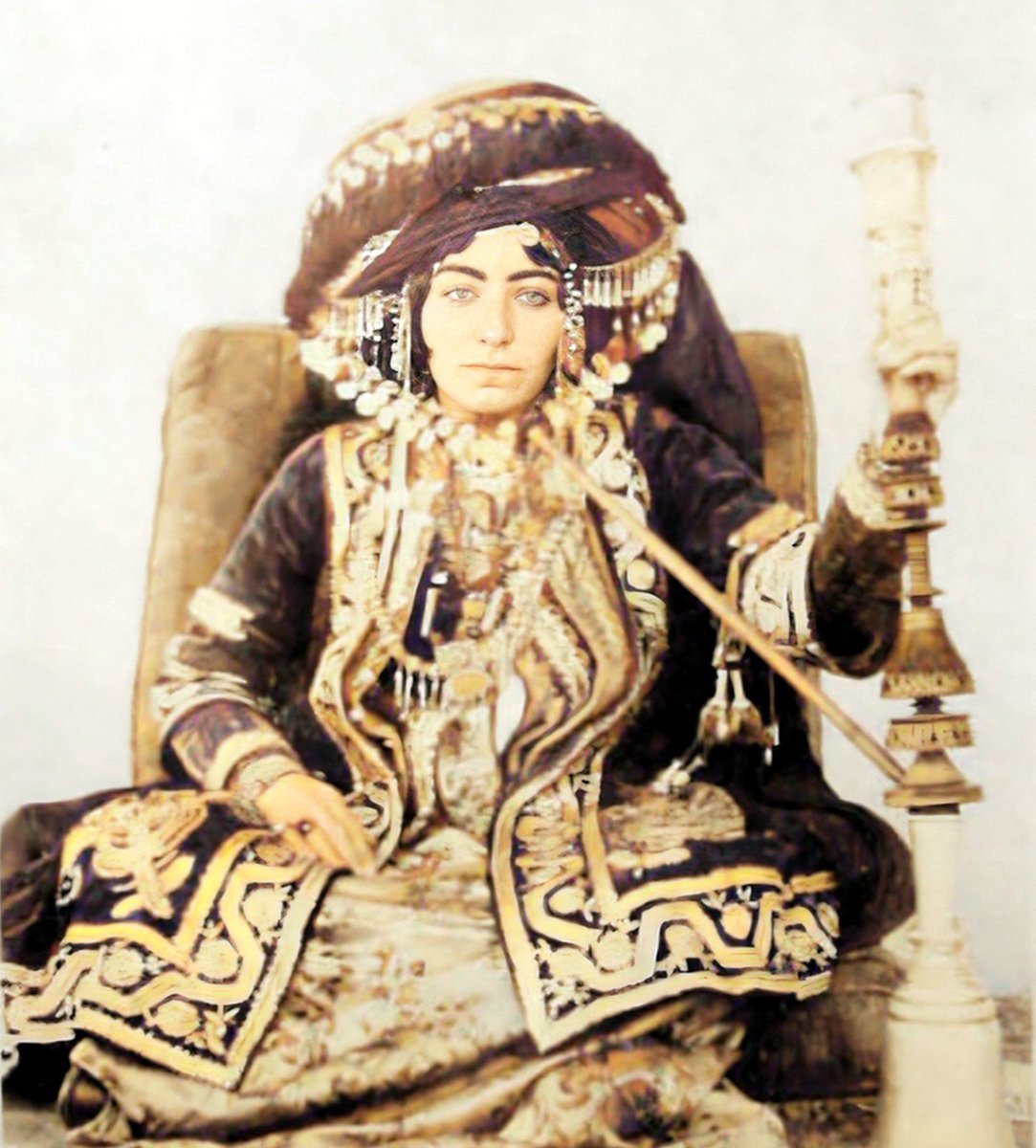 Kurdish woman in traditional attire smoking kalyan, 1916-1918.