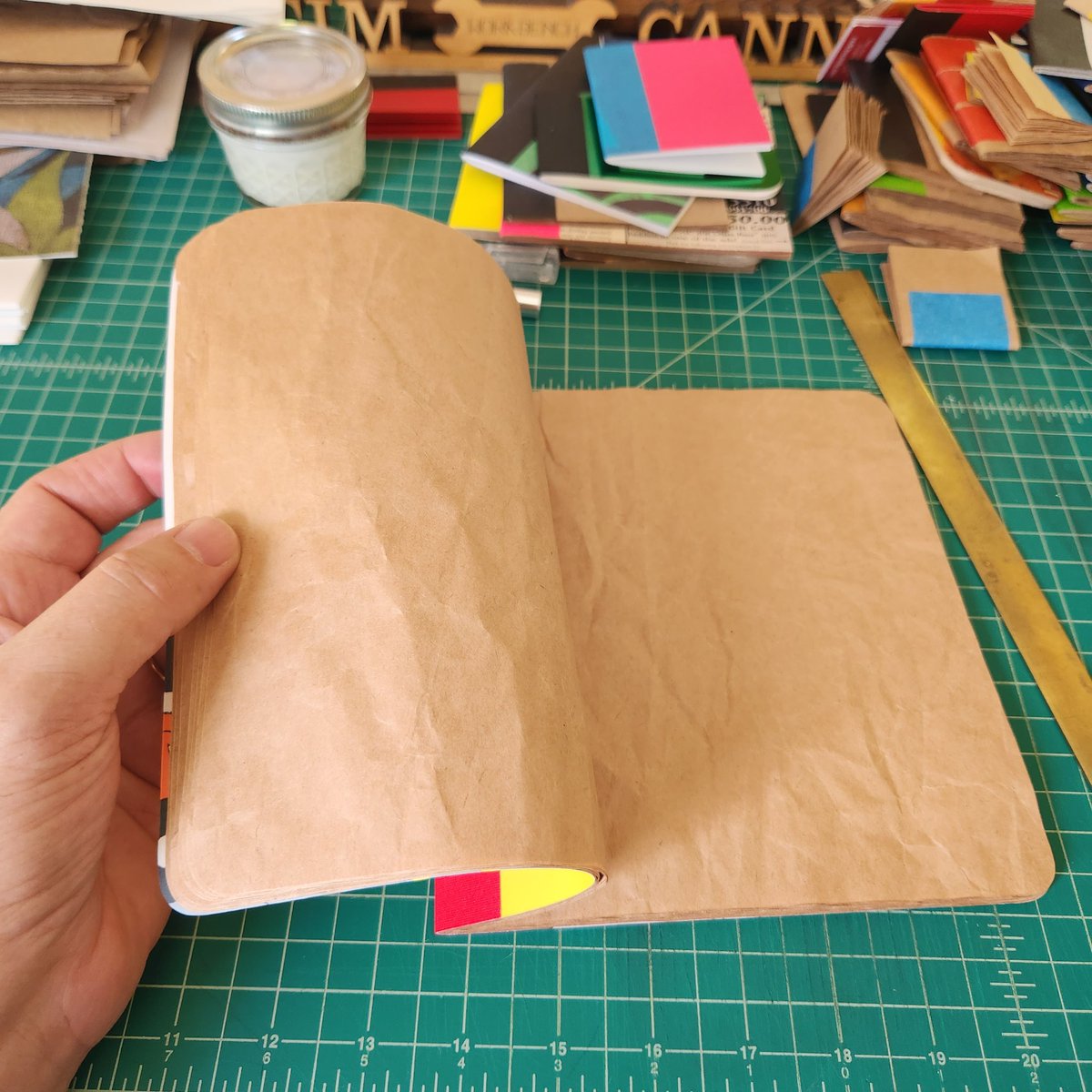 tcanny's tweet photo. Just made an upcycled blank coloring book for my grand using kraft packaging paper and pages from a thrifted copy of #GregPizzoli's great #picturebook Number One Sam. #catchpennybooks #upcycled #ammaking #ambookbinding #bookarts #kidlit https://t.co/Z7itvcohIv
