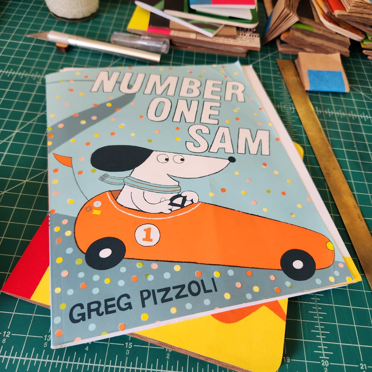 tcanny's tweet photo. Just made an upcycled blank coloring book for my grand using kraft packaging paper and pages from a thrifted copy of #GregPizzoli's great #picturebook Number One Sam. #catchpennybooks #upcycled #ammaking #ambookbinding #bookarts #kidlit https://t.co/Z7itvcohIv