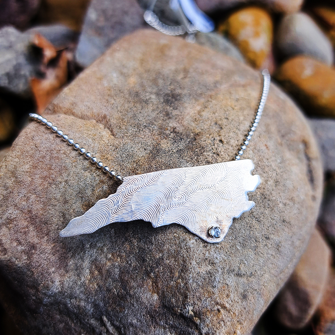 EclipseAtBM's tweet photo. A cubic zirconia marks your hometown of Wilmington on this sterling silver North Carolina necklace by Barbara Bennett Designs. Wear your love!

#EclipseAB #shoplocal #wilmingtonnc #handmade #northcarolina #sterlingsilver https://t.co/YsVM8riJ0g