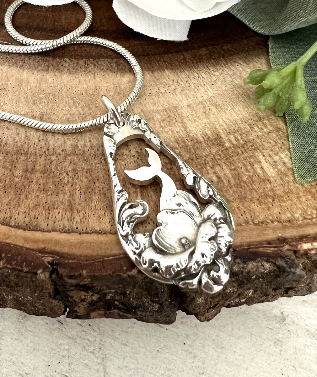 NEW! Mermaid/whale tail pendant cut out from a sterling silver butter spreader handle. Love how it looks like the tail is coming  out from the flowers! Does it look more like a mermaid or a whale tail to you?
.
.
#mermaidtail, #whaletail, #spoonjewelry, #upcycled