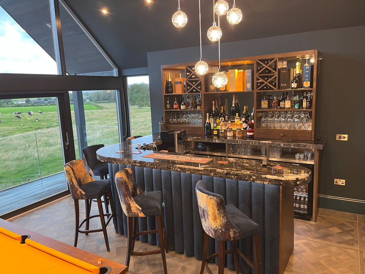 This home bar is a showstopper!

From the illuminated walnut back bar to the plush indigo velvet column bar frontage, every part of this bar is sure to impress guests.

We worked closely with the customer to craft this bespoke home bar that combines beauty and functionality.