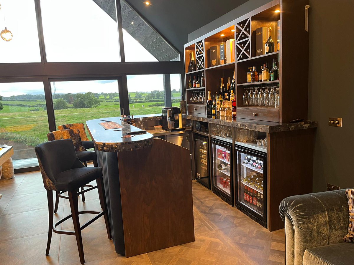 Dawnvale's tweet photo. This home bar is a showstopper!

From the illuminated walnut back bar to the plush indigo velvet column bar frontage, every part of this bar is sure to impress guests.

We worked closely with the customer to craft this bespoke home bar that combines beauty and functionality. https://t.co/mzd9kmtAbs
