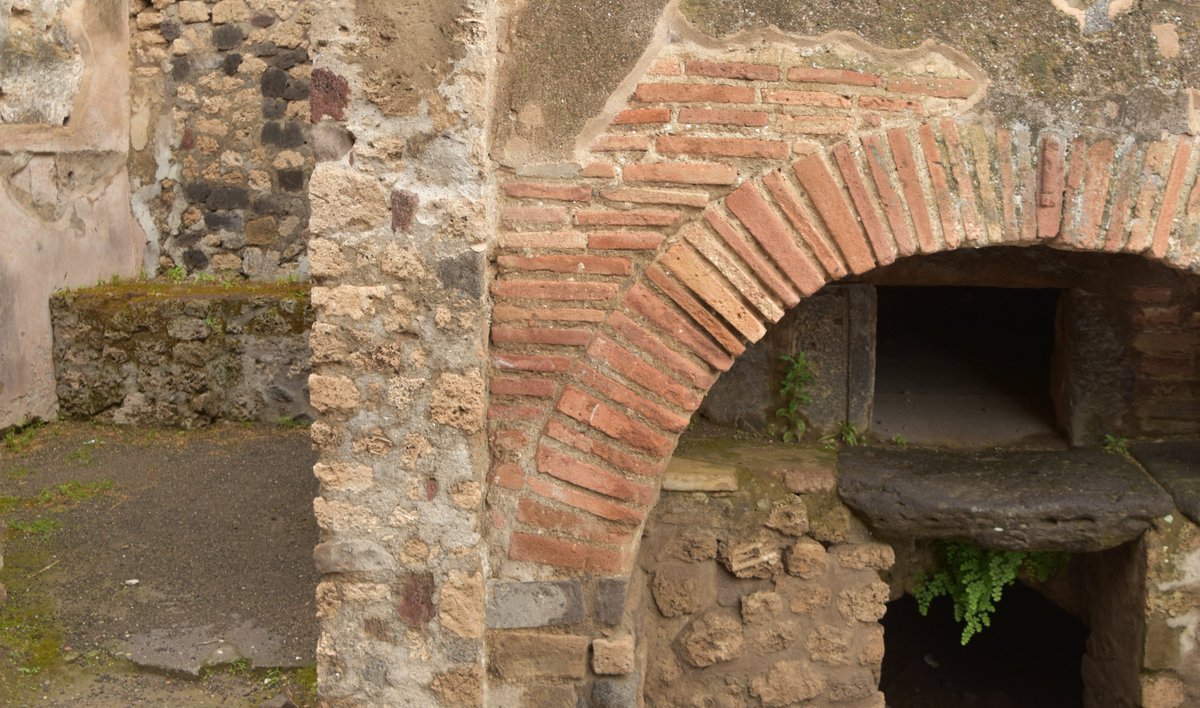 pompeii_sites's tweet photo. Often associated with the ovens and mill rooms were kneading rooms that contained a counter on which the dough was prepared for baking. Evidence of kneading machines has also been found as have containers for the grain that once had their volume inscribed on their rims. https://t.co/ooKSg6EJ0O