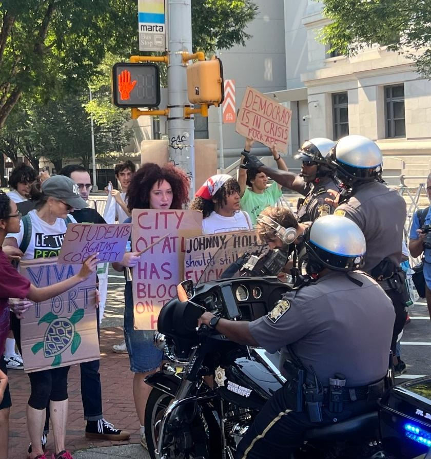 defendATLforest's tweet image. #StopCopCity advocates in Atlanta face down police intimidation outside the Federal Courthouse. Will the City of Atlanta government dare throw out thousands of voter signatures qualifying a referendum on Cop City?