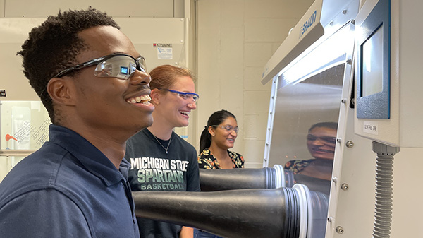 MSU_EGR's tweet photo. Doctoral students and staff in the college’s Hickey Group - Lincoln Mtemeri, Charley Hengesbach, and Sharmila Samaroo – work in the Hickey Lab to improve redox flow batteries. Read more on their efforts at: https://t.co/xQhhFQhRH2 https://t.co/7Oxi8dQ6XV