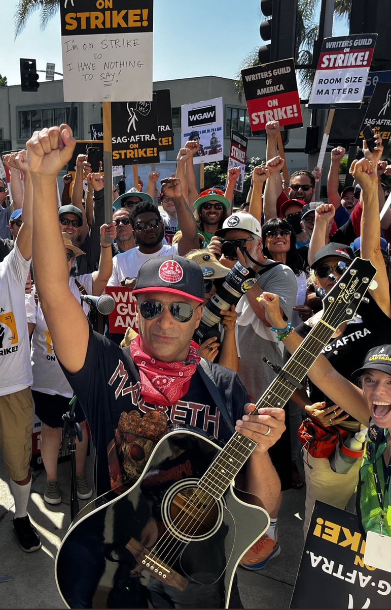 tmorello's tweet image. “For Joe Hill and Caesar Chavez who fought in their own time/For our brothers and our sisters up and down that picket line/For the unnamed and unnumbered who struggle brave and long/For the union men and women standing up and standing strong!”
