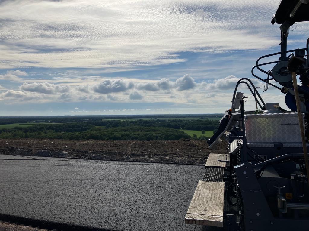 ProvDrenthe's tweet photo. Vandaag zijn de aannemers begonnen met het asfalteren van het fietsparcours op het Dak van Drenthe, het nieuwe hoogste punt van de VAM-berg in Wijster. Na het aanbrengen van de eerste laag vandaag worden donderdag en vrijdag laag twee en drie aangebracht. (1/2) https://t.co/p13z1B8hHF