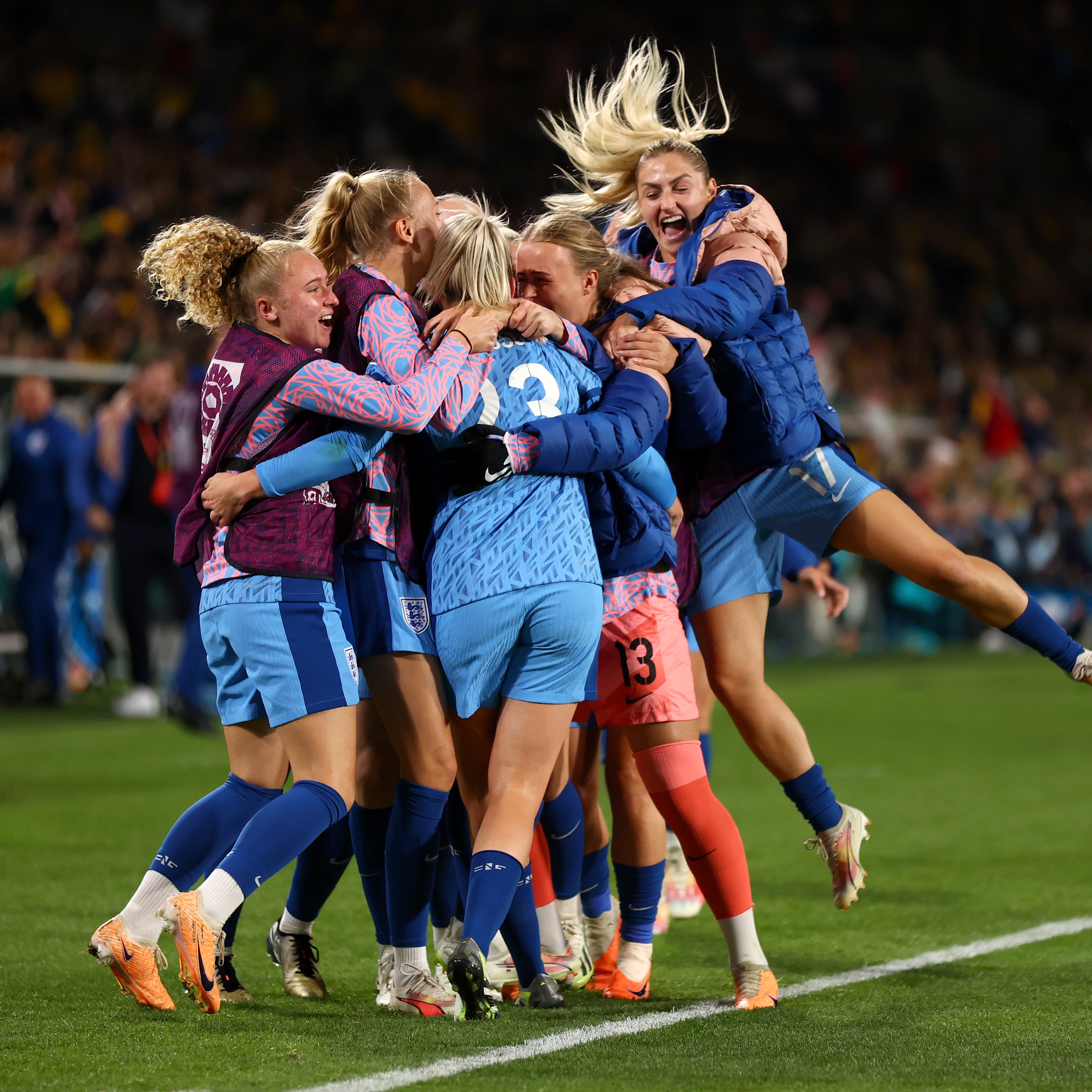 A group of Lionesses players celebrate Alessia Russo's goal