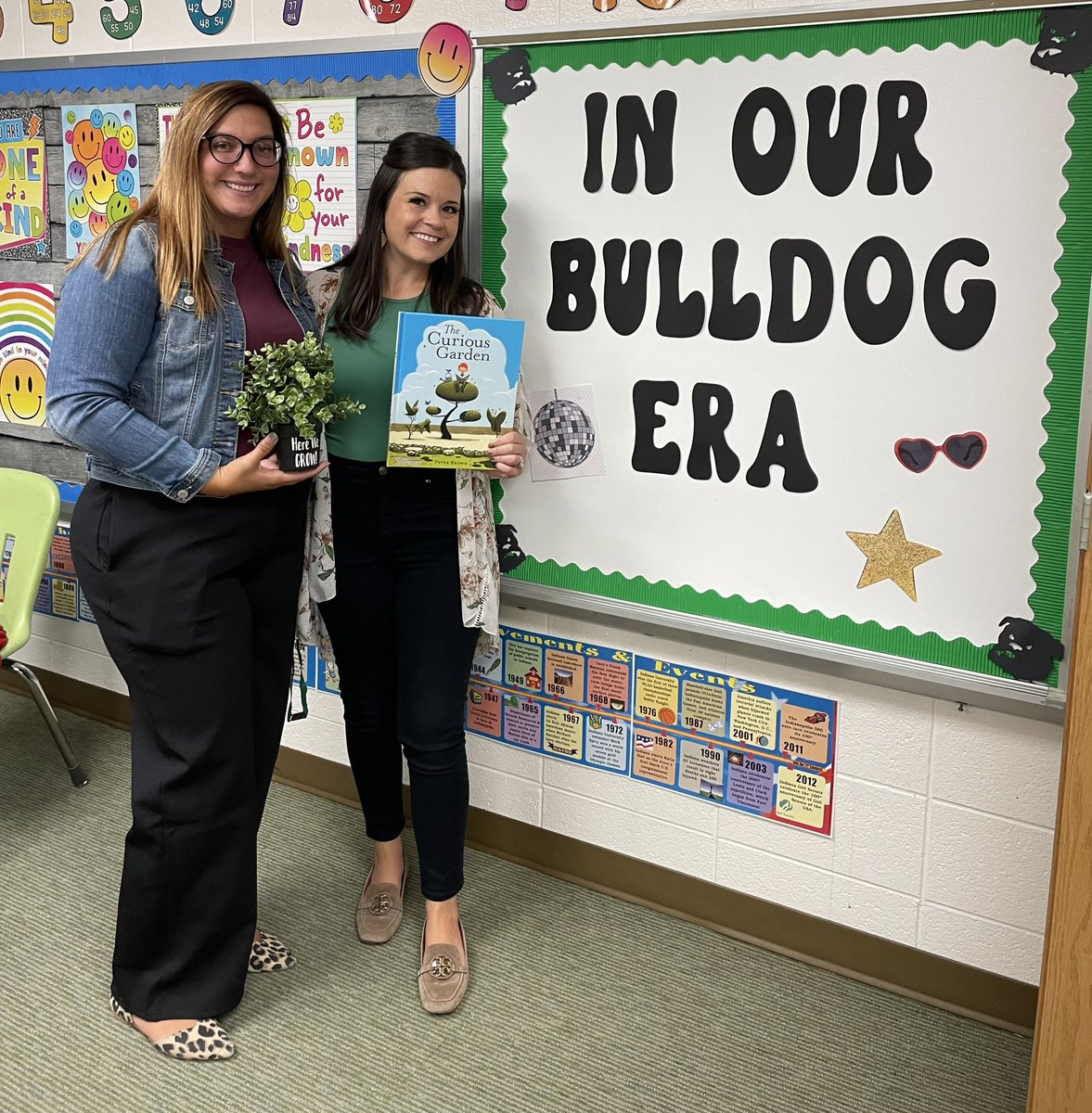 Here We Grow Again

This is the theme for the school year at CCE. 

Mrs. Smith and Mrs. Golden have been touring the school visiting every classroom to share our theme and welcome our students with a read aloud “The Curious Garden” and gifting each classroom a plant 🪴