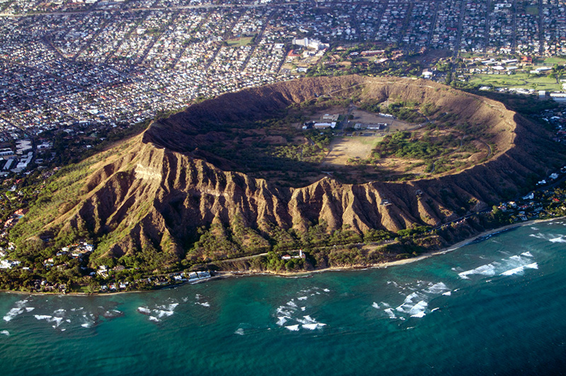 Diamond Head in O'ahu, Hawaii, formed over 300,000 years ago when a volcano underneath the surface erupted, transforming the landscape. Early Western explorers mistook its calcite crystals for diamonds, and that is where the name came from. 

However, the Hawaiian name for