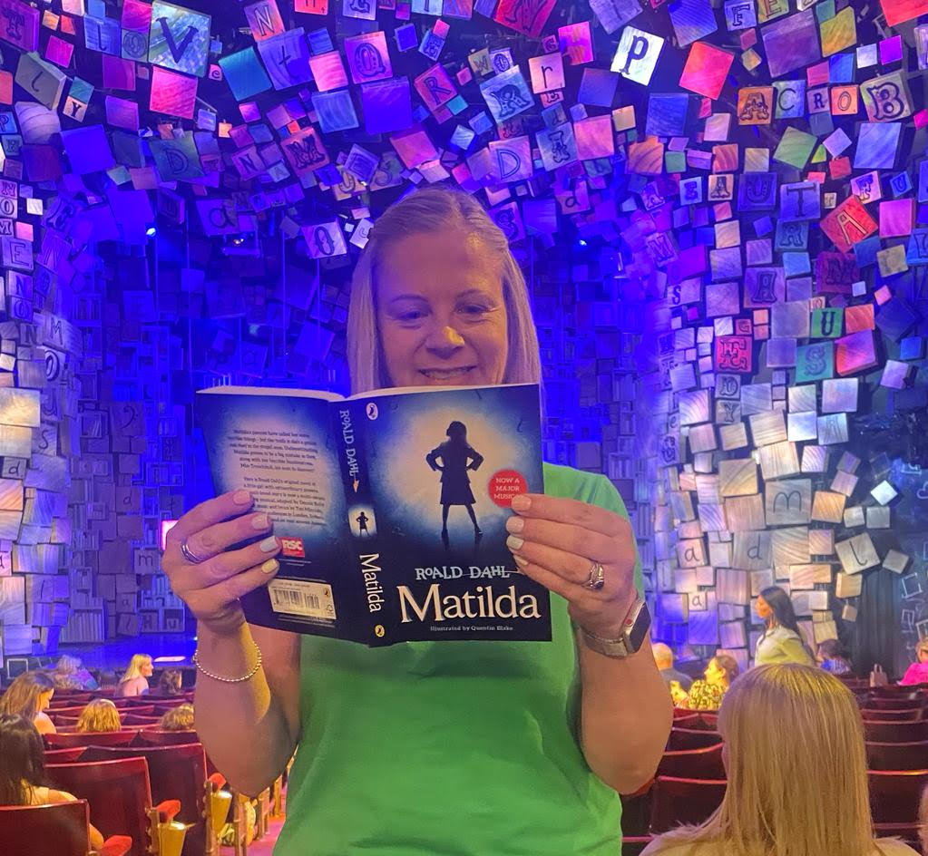 MillthorpeSch's tweet photo. Here is Mrs Rothenburg reading Matilda, at the Cambridge Theatre in London, right before watching Matilda the musical #BeOutrageous #Gothewholehog #MillthorpeReads https://t.co/fjJhBv4CL5