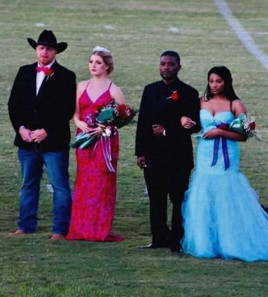 The girl in the blue dress was elected homecoming !
The girl in the red dress lost her mom that morning but her dad made sure she got to homecoming.
The girl in the blue dress took the crown off her own head and placed it on the head of the girl in the red dress.
That's the