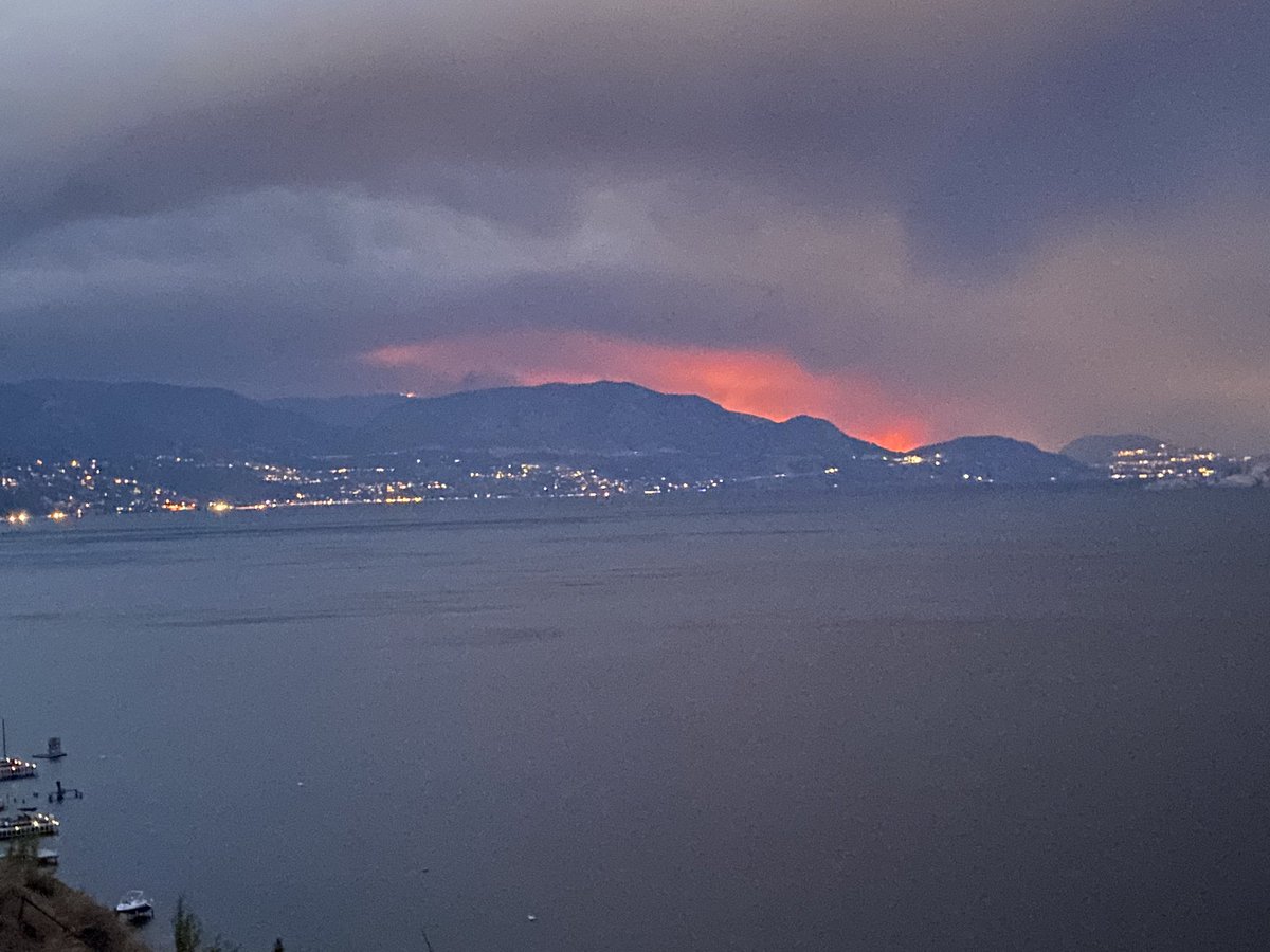 JennPound's tweet photo. Easier to see the extent and glow of the West Kelowna fire at night. Taken From Peachland. Stay safe everyone. 💕 https://t.co/8Cn6qsrwv3