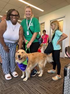 FlyILG's tweet photo. What a paw-fect day. 🐾 Kicking off a busy Labor Day weekend with a visit from @PAWSforPeople! 🐕 Their trained therapy dogs did an amazing job greeting &amp; comforting our @AveloAir passengers during the busiest flight time of the year at ILG. 😍 #FlyILG #PawsForPeople https://t.co/XB0yYMloh3