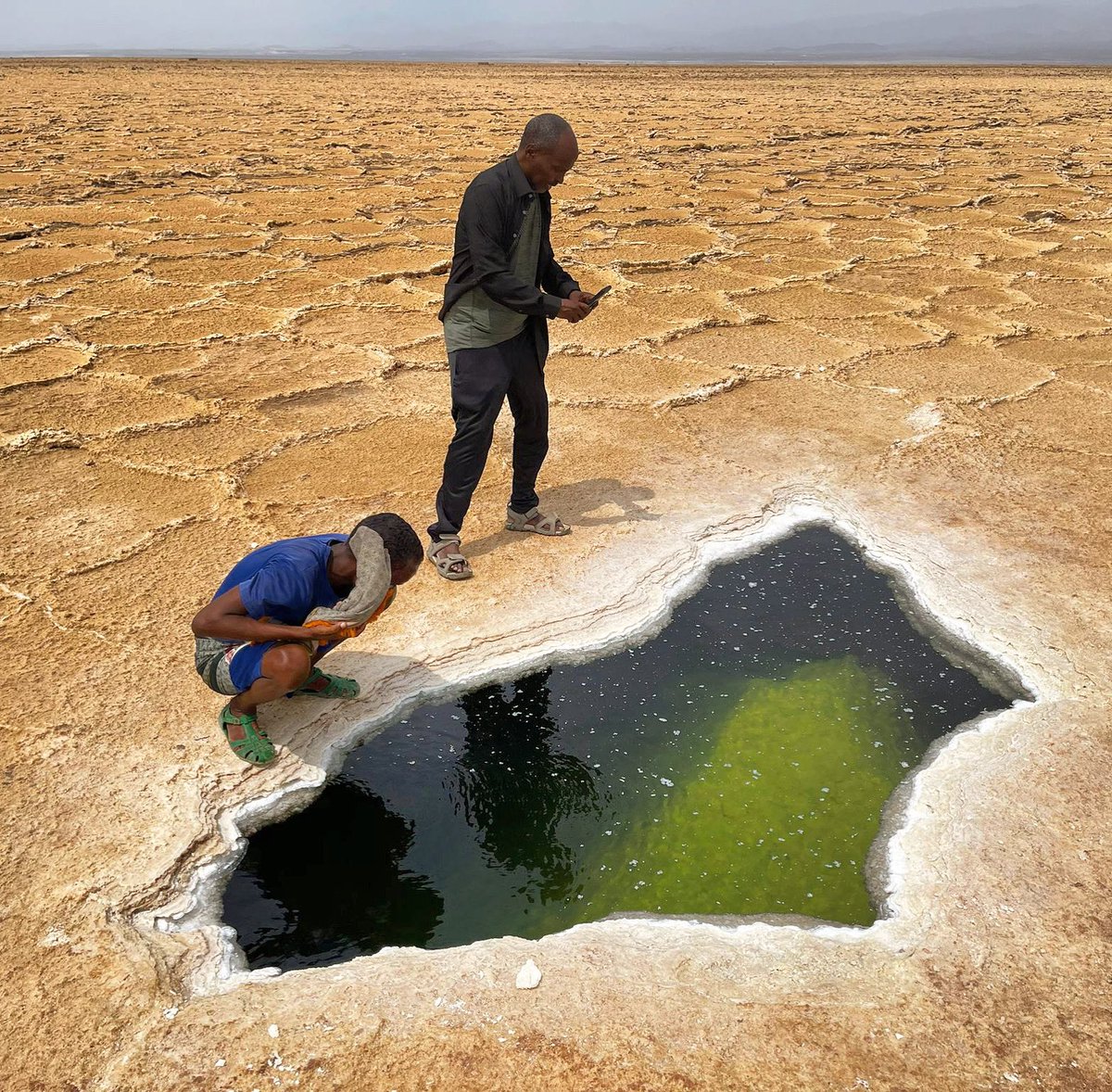 CanGoAfar's tweet photo. Asa’ale is an opening in the salt flats near Dallol, through which you can see an enormous cavern of saline/briny water under the salty crust surrounding it. #mission13 https://t.co/X7QbdXyOcC
