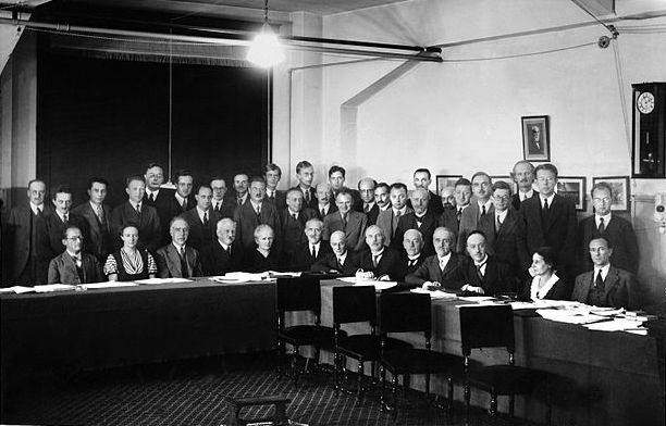 Participants in the 7th Solvay Conference, Bruxelles (October 1933).

Seated [L-R]: Erwin Schrödinger, Irène Joliot-Curie, Niels Bohr, Abram Ioffe, Marie Curie, Paul Langevin, Owen Willans Richardson, Ernest Rutherford Théophile de Donder, Maurice de Broglie, Louis de Broglie,