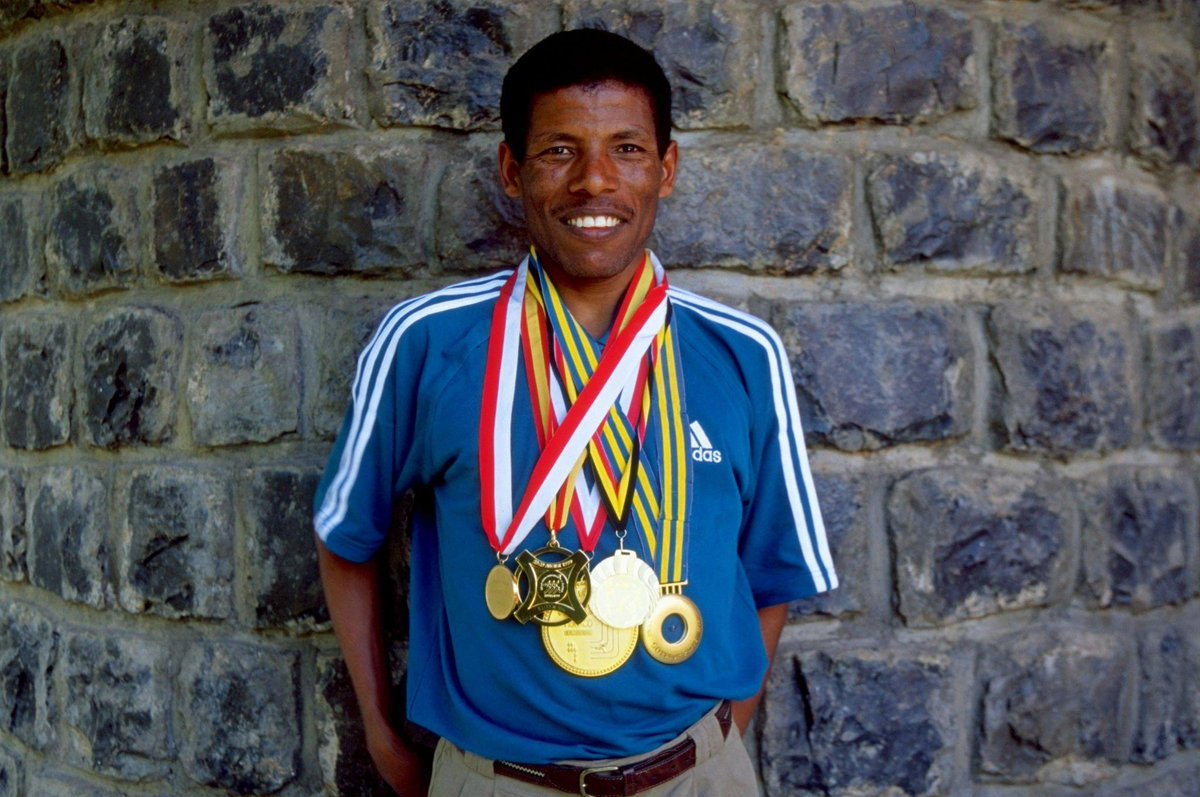 biniamhirut's tweet photo. Haile Gebreselassie with his medal collection on a feature shoot in Ethiopia, Dec 1999 https://t.co/X6pjIK8YTm