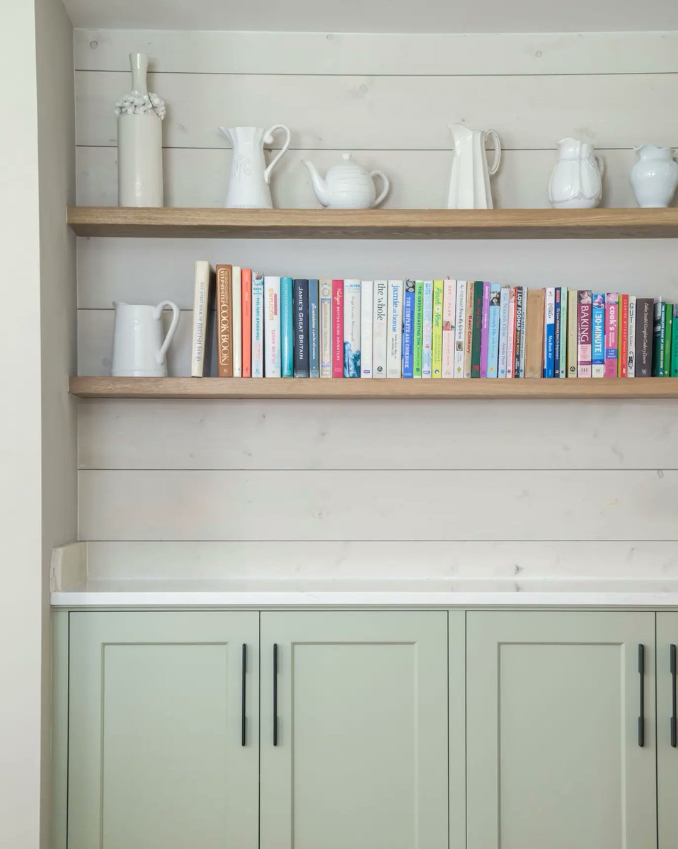 Our customer wanted to be able to use shiplap in her kitchen design and we made sure to display its understated warmth in ways that complimented our fine cabinetry. 

As the backdrop for a thoughtful worktop and shelf area as well as in the end panels of the statement island.