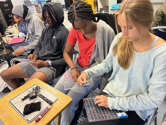 JaneWHerndon's tweet photo. A fun and creative way to review vocabulary words: Geoboarding! @SenoraGante calls out words, &amp; students demonstrate their understanding of Spanish by weaving shapes, words, patterns, and pictures. #GoBJHS https://t.co/hxQV4IB7GE