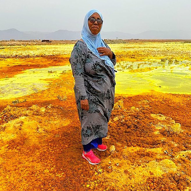 CanGoAfar's tweet photo. Mission 13 co-lead Aicha Youssef stands in the sulphuric landscape of Dallol, Ethiopia near the northern border with Eritrea. One of the most remote tourist sites in Afar, Dallol holds the record for the hottest avg temperature (35 °C) for an inhabited place on earth. https://t.co/gERbp58WUX