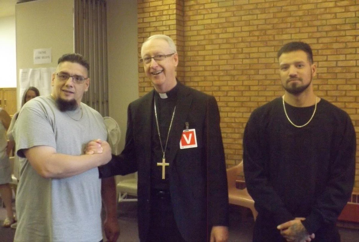 archedmonton's tweet photo. Archbishop Smith visited and celebrated Mass with inmates at the #GrandeCache Institution on June 10. 
We just received this photo of His Grace with two inmates. 
Please pray for all inmates throughout Alberta, for all of their needs and for those who work in prison ministry! https://t.co/ijsUzn7bZx