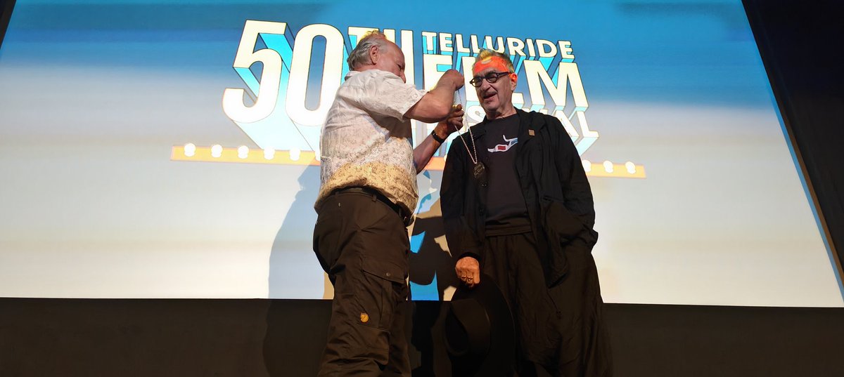 Wim Wenders gets his silver medallion here in Telluride film festival last night from...Werner Herzog