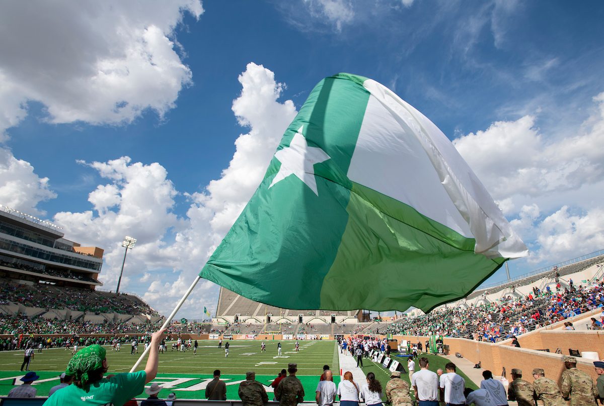UNTAlumniAssoc's tweet photo. It's #MeanGreenFriday on the eve of our first home game of the season! Throw up those talons and give us a #GMG! 🦅 https://t.co/N9akjEbykh