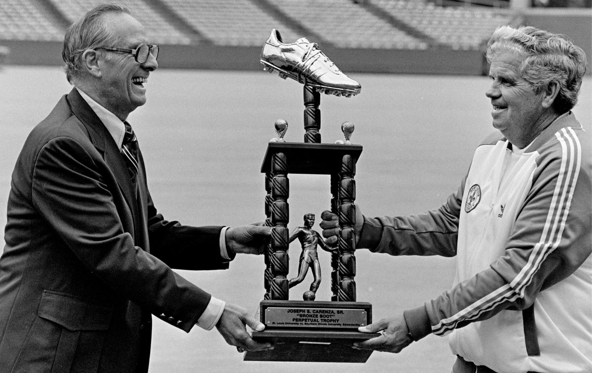soccermadeinstl's tweet photo. The Bronze Boot games, played by @SLUMensSoccer &amp; @SIUEMensSoccer, &amp; @SLUWSoccer &amp; @SIUEWSoccer, resume tomorrow @stlCITYPARK. This 1982 photo shows legendary coaches Bob Guelker (left) of SIUE and Harry Keough of SLU with trophy at Busch Stadium 2.  Photo courtesy Rick Stankoven https://t.co/j94zJw90bG