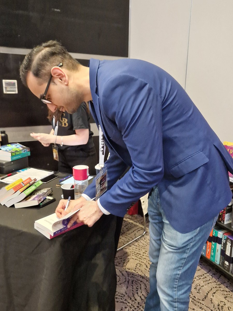 The wonderful @AwaisKhanAuthor signing his books for me. Such an honour. Incredible books and lovely man. Glad we got to share a rubbish maccy Ds and chat for a but in amongst the madness. #capitalcrime #CapitalCrime23 #stpauls