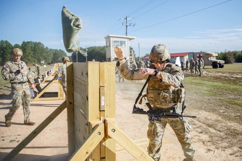 82nd Airborne Division paratrooper throws a sandbag over a wooden barrier during a stress shoot. This event is designed to measure the physical fitness and shooting capabilities of a Paratrooper in a stressful environment. #82ndairborne #paratroopers