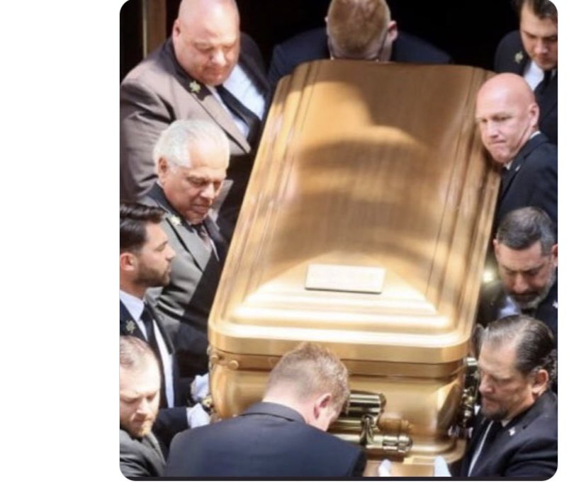 You can see the strain on the faces of these ten men’s faces, carrying a coffin with only cremated ashes in it.  It’s just so perplexing isn’t it?