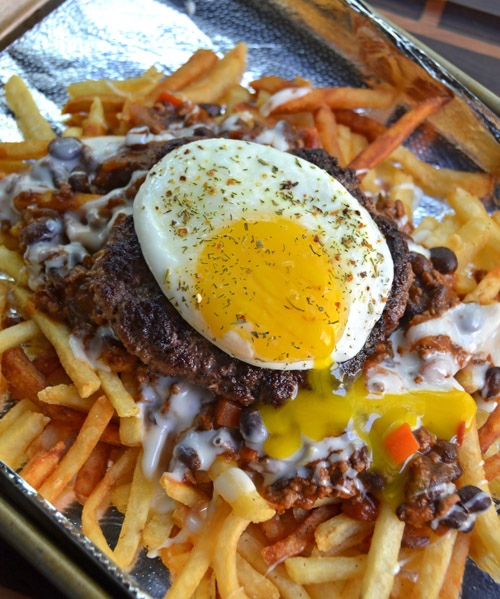 I cooked some 8oz burgers on the Egg to make the Rue Morgue burger ala Poe's Tavern - Bunless burger on bed of fries, chili, queso and topped with a sunny-side-up egg. It's a delicious train wreck!