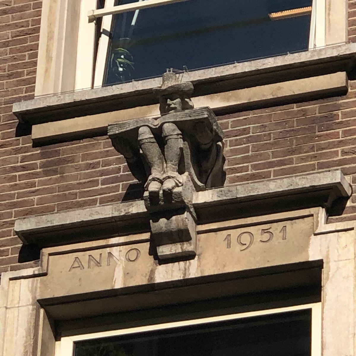 Modern gable stone of a man reading (Spuistraat, Amsterdam) #bookhistory