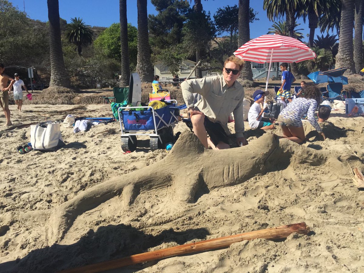 Just another fun day at the beach with Conan and Sandy the Shark. Conan is wearing so much sun block it looks like a shirt. #teamcoco