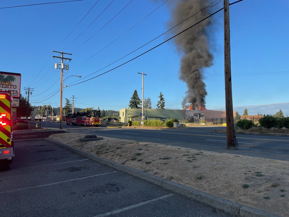 PuyallupPD's tweet photo. We are at the scene of a commercial fire at the old cold storage facility in the area 15th St SE and East Pioneer. Several road closures in the area. Avoid the area. Fire needs access for responding units. This is now a second alarm commercial fire for Central Pierce Fire. https://t.co/laF0ePHNP6
