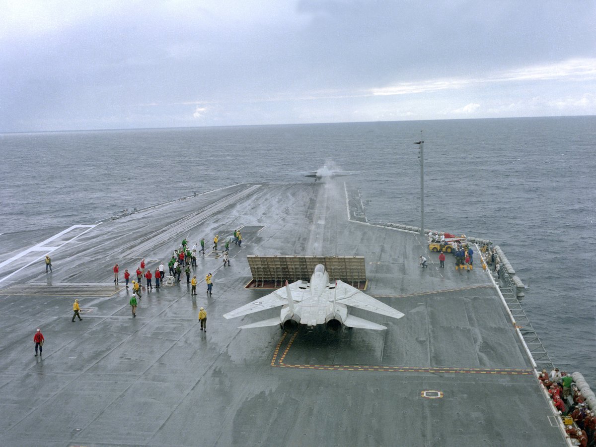 A Turkey from VF-41 waits behind the jet blast deflector as another #Tomcat aircraft is launched from the No. 1 catapult aboard USS Abraham Lincoln CVN-72 in 1990. #tomcattuesday #f14 #f14tomcat#flynavy#cvn72#ussabrahamlincoln#aviationsafari#aviationpreservation#boneyardsafari