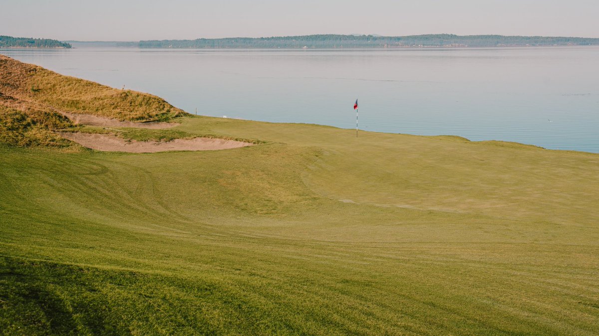 fried_egg_golf's tweet photo. Hole of the Day - Chambers Bay

No. 16 - par 4 - 396 yards

Playing parallel to the railroad tracks and Puget Sound, this short par 4 affords players ample room left to play away from trouble but it leaves a difficult approach across the narrowest green on the course with the ground running away. Taking on the deep waste bunker down the right leaves a much simpler shot up the slope of the green.