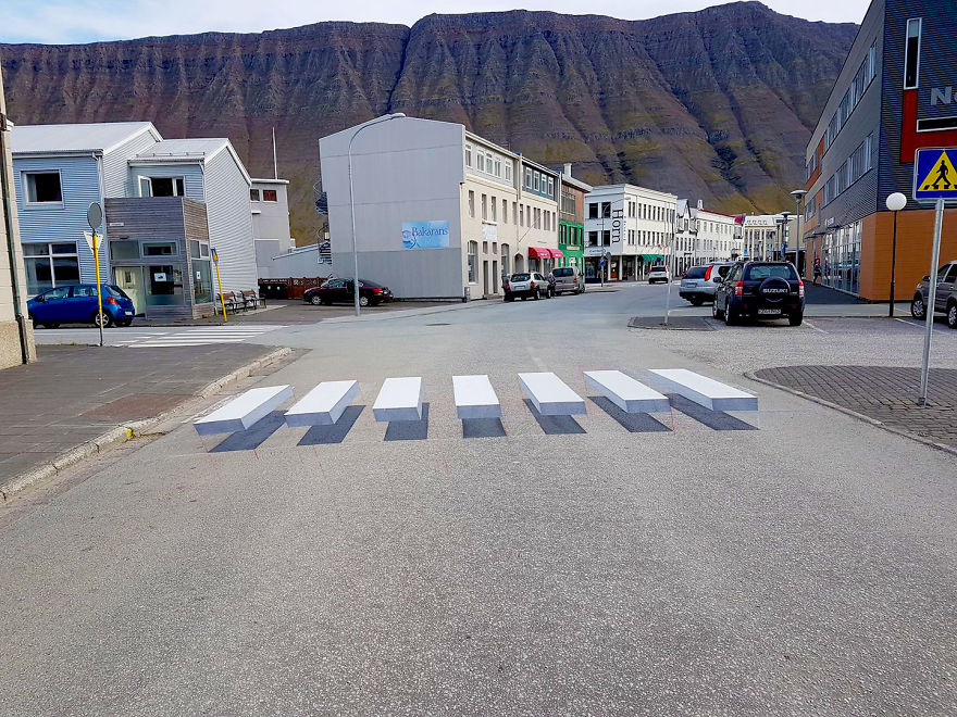 Art Meets Traffic Safety in Iceland! 🇮🇸 
Behold the mesmerizing 3D crosswalk that captivates and slows traffic with its stunning optical illusion. Kudos to boredpanda for sharing this ingenious concept! Safety and art intertwine on the streets. 🚦#TrafficInnovation #3DCrosswalk