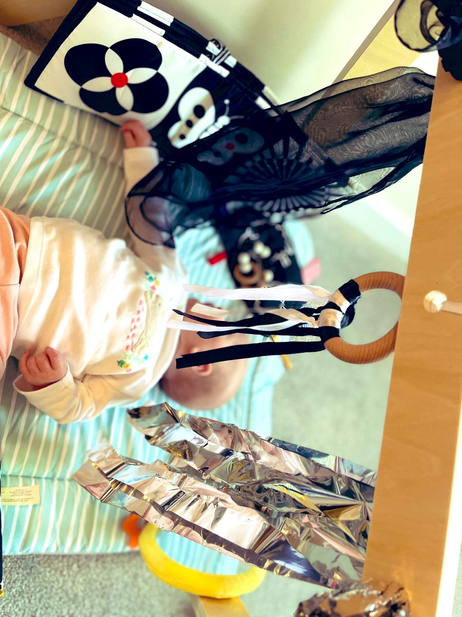 MrsAEYFS's tweet photo. Baby E is loving her little play area. Changing the bland baby gym toys to some sensory items has encouraged so many smiles and so much ‘chatting’. She loves grabbing the foil blanket. 🖤🤍 #babyplay https://t.co/V01dSwa9UC
