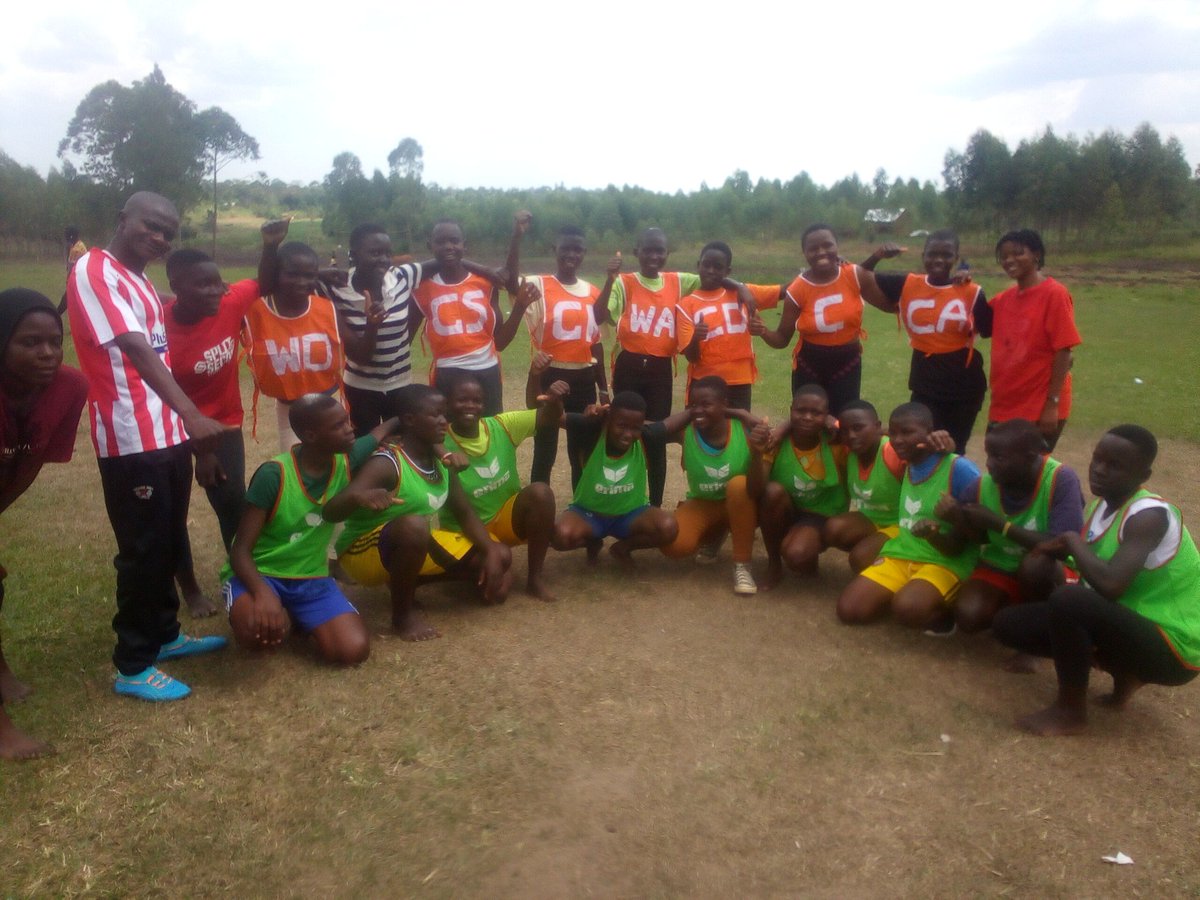 NakigoS's tweet photo. Senior three Squatting while Senior one is standing. They posed for a photo as they prepare a match this afternoon. #Binancelunchforchildren @BinanceBCF https://t.co/Xy4C2RUo3h