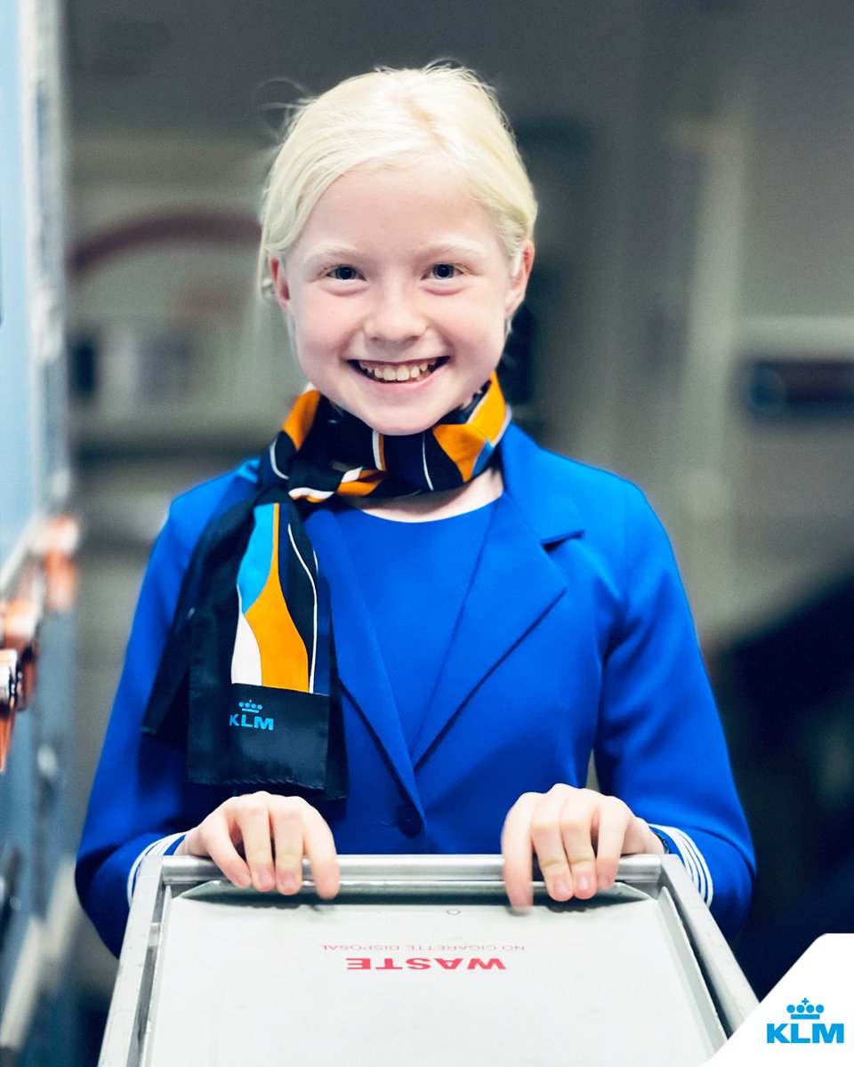 KLM's tweet photo. Little helper, big dreams! 🛫✨ Mini cabin attendant Valérie definitely has what it takes to become KLM’s next CA-superstar. #KLM #YoungAviator #KLMJuniorCrew #FutureInFlight @Jordisoeters https://t.co/coRTbVlYAM