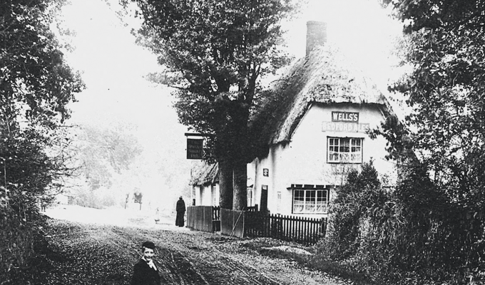 Can anybody help us to figure out where this photograph was taken and when? It is a pub but unfortunately the signage is unreadable to us here at the archives!