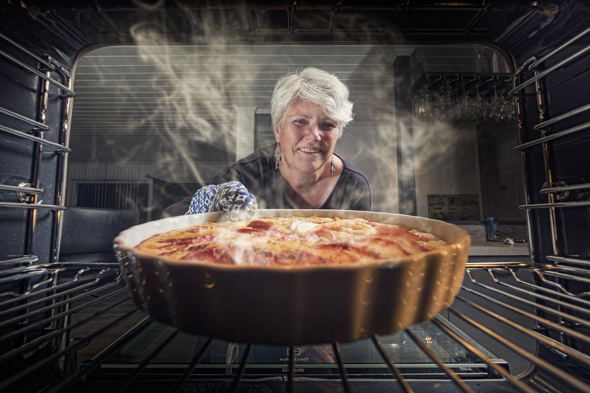 Woman Checking On Pie In The Oven by Finn-b tinyurl.com/vr6ua2jb