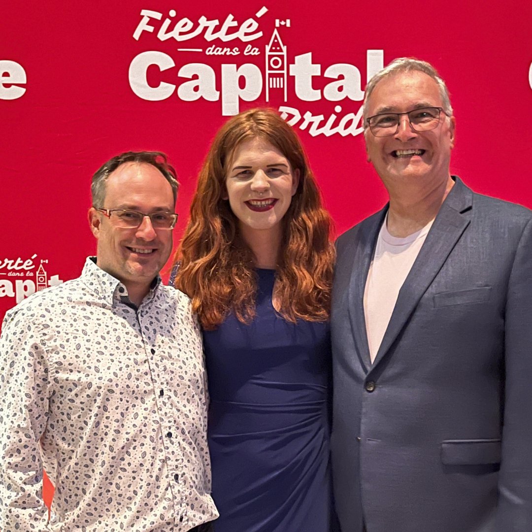 CGOGMC President (Guy Delorme) and Secretary (James Anderson) with Capital Pride 2023’s Grand Marshall (<a href="/FaeJohnstone/">Fae Johnstone 🏳️‍⚧️🏳️‍🌈</a>) at the Festival Launch board by the National Gallery of Canada.