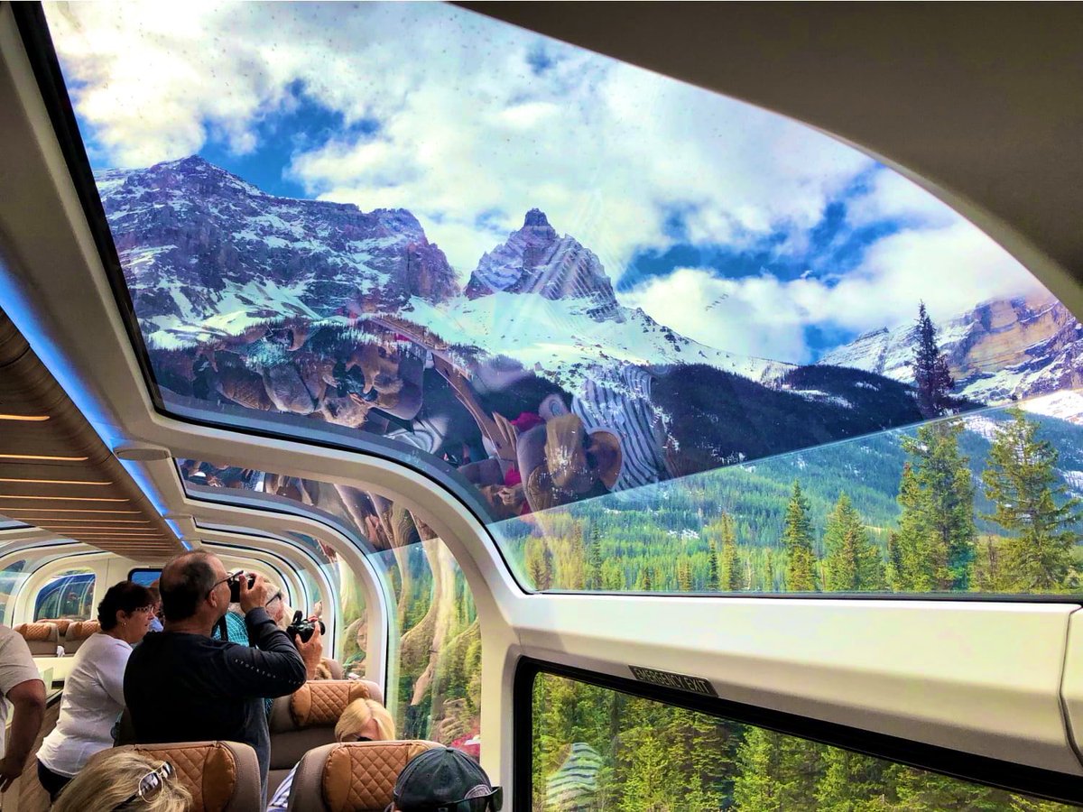 MRutchland's tweet photo. This particular train is operated by Rocky Mountaineer and they are a private railway company that operates luxury train journeys through the Canadian Rockies.

The passenger train in the Canadian Rockies is designed to maximize the views of the stunning scenery. The cars are equipped with large windows and glass-domed roofs, so passengers can enjoy the views from all angles. The trains also have comfortable seats and amenities such as dining cars and observation cars.

The seats are comfortable and reclining, so passengers can relax and enjoy the journey.

The dining cars offer a variety of meals and snacks, so passengers can eat and drink while they enjoy the views.

The observation cars have large windows and a bar, so passengers can relax and enjoy the views while they have a drink.