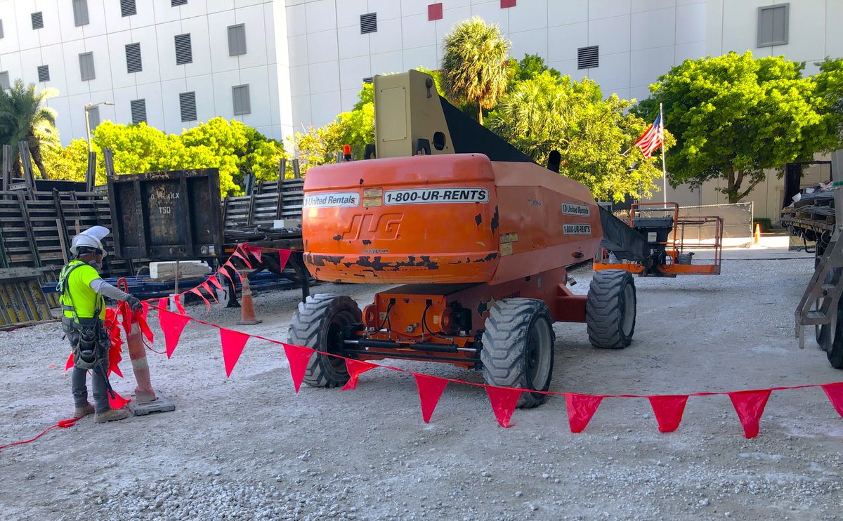 Our employees practice safe acts across the jobsite to ensure every inch of a Tribco project is safe! Here, an employee is flagging off the work area around an aerial boom lift to protect people on the ground from the work above.